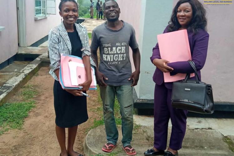 Tezela poses with Legal Aid Officer Catherine Mkonda and Principal Legal Aid Advocate Tiwonge Penama