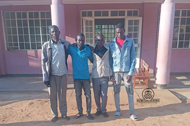 The four accused pose for a photo outside Court