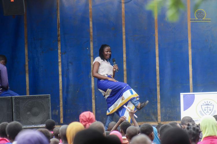 Principal Legal Aid Advocate Janet Mkomera Kamoto mixes dancing with presentations to send messages during an awareness activity in Salima